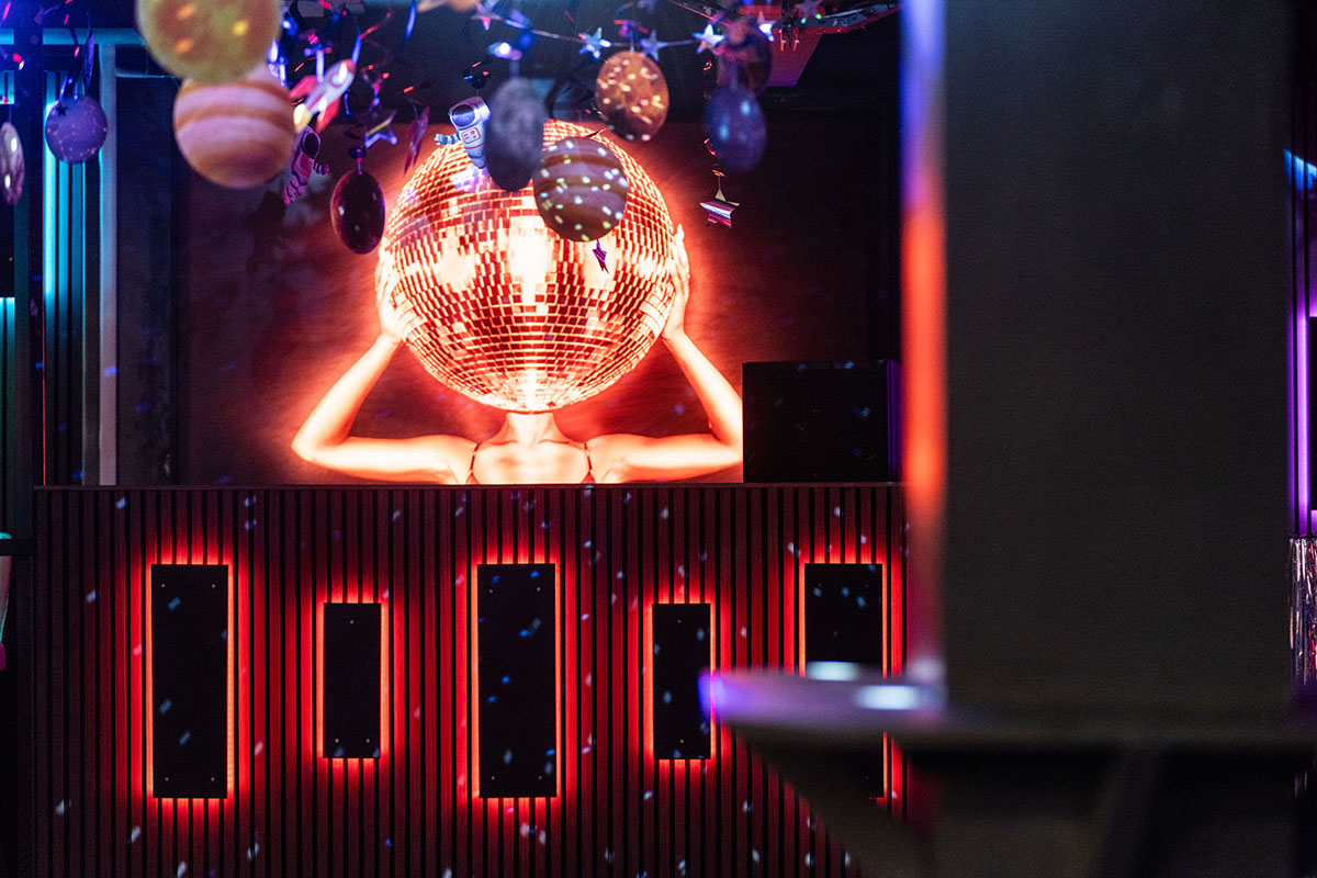 Disco ball and red neon lighting inside Elev8 nightclub